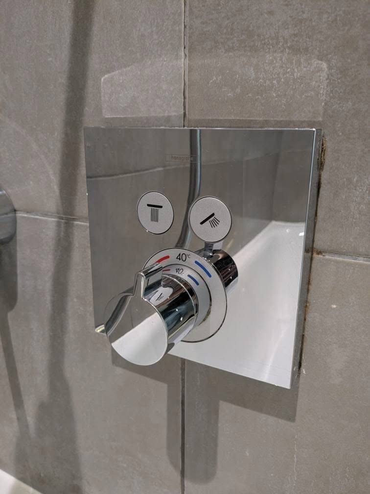 Shower tap and fittings after cleaning — gleaming